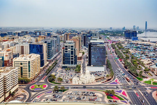 Aerial view on Deira City Center in Dubai, UAE, on a summer day with expensive hotels and roads. Scenic travel background.