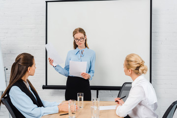 beautiful young businesswomen having conversation with boss at modern office
