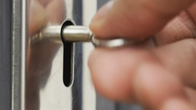 Closeup hand of someone is using key open the door 