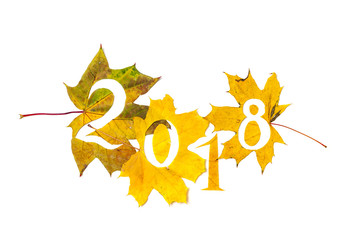 2018. figures carved from yellow maple leaves