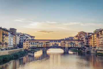 Fototapeta na wymiar Scenic view on Ponte Vecchio in Florence, Italy, on a summer day with dramatic clouds. Travel background.