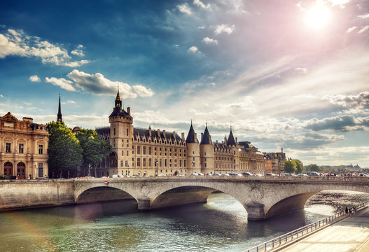 Beautiful skyline of Paris, France, with Conciergerie, Pont Neuf at sunset. Colourful travel background. Romantic cityscape.