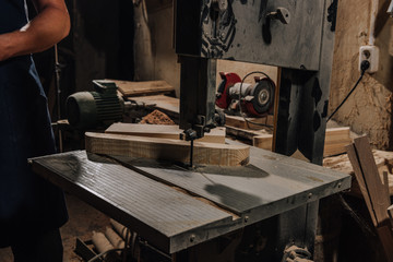 Fototapeta na wymiar partial view of woodworker at wooden workshop