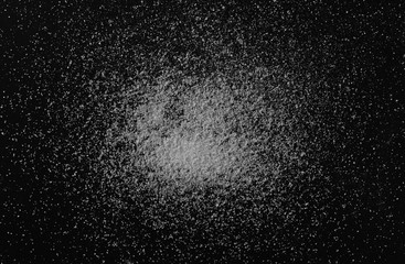 Salt crystal pile isolated on black background, top view