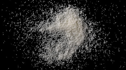 Pile of shredded coconut meat isolated on black background, top view