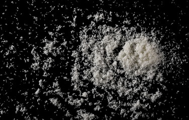 Pile of shredded coconut meat isolated on black background, top view