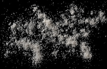 Pile of shredded coconut meat isolated on black background, top view