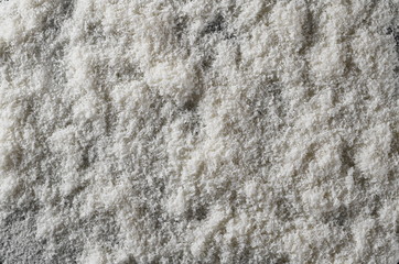 Pile of shredded coconut meat isolated on black background, top view