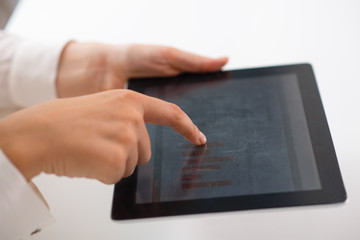 Business professional reviewing analytics with mobile computer. Closeup of human hands holding tablet with bar charts on screen. Marketing analysis concept