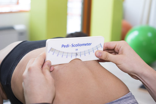 Scoliosis Screening with Pedi-Scoliometer on young person spine