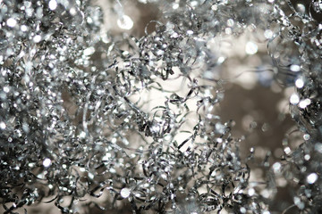 Shiny serpentine tinsel close up with blured background