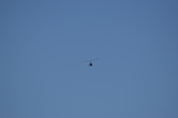 Modern helicopter flies in the sky