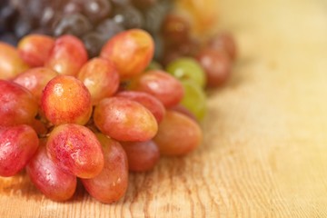 bunch of fresh grape on light wooden background