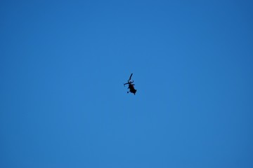 Modern helicopter flies in the sky