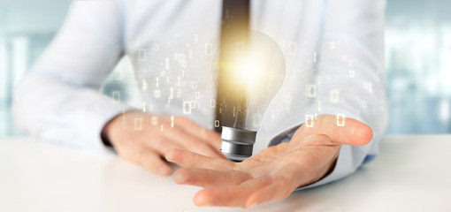 Businessman holding a bulb lamp idea concept with data all around 3d rendering