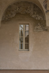 Fototapeta na wymiar Archway, Columns and Courtyard: reflected in the Glass of a Window