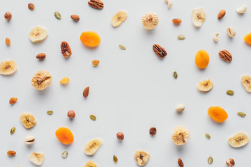 flat lay with delicious dried fruits and nuts with copy space isolated on white background