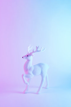 White Santa's reindeer in vivid gradient neon colors. Christmas minimal background concept.