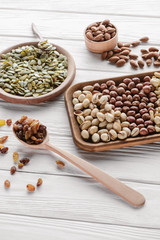 tasty nuts and raisins on white wooden surface