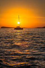 Sail boat against sunset