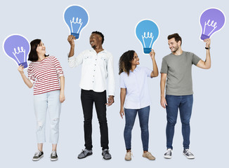 Naklejka premium People carrying light bulb icons