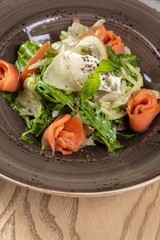 Red fish healthy salad with mixed lettuce leaves