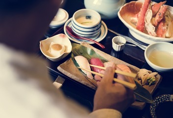 Man eating Japanese food at restaurant