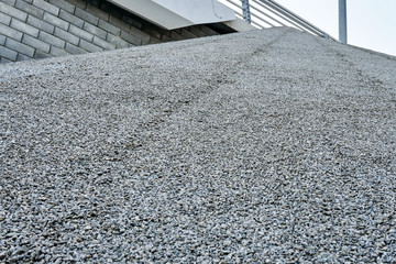 Texture of fine gravel glued to an inclined surface for beauty and strength
