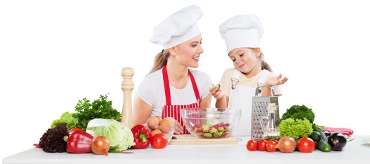 mother and daughter prepare salads