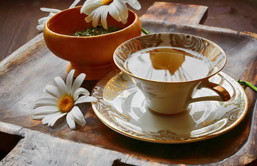 Herbal tea with mint, lemon grass and chamomile in the porcelain cup 