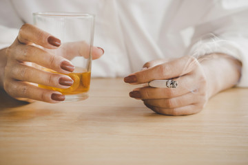 depressed woman hands drinking alcohol and smoking cigarette lonely 