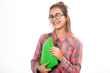 Student of high school holding a green folder in her hands. Young beautiful girl in glasses. Smiling student
