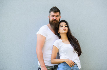 Feel their style. Couple friends hang out together grey wall background. Youth stylish outfit. Couple white shirts cuddle each other. Hipster bearded and stylish girl hang out urban romantic date