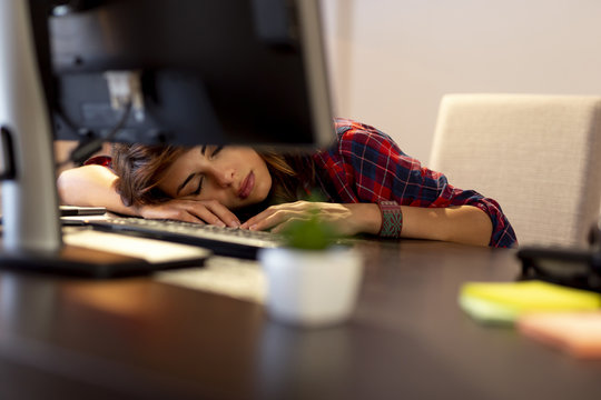 Worn Out Woman Asleep At Her Desk