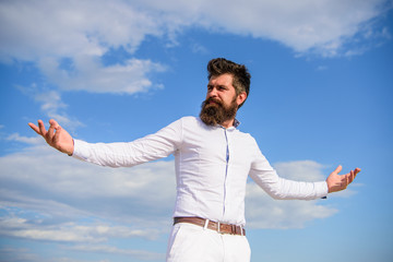Reached top. Power and freedom. Hipster with beard and mustache looks attractive fashionable white shirt. Guy enjoy top achievement. Man bearded hipster formal clothes looks sharp sky background