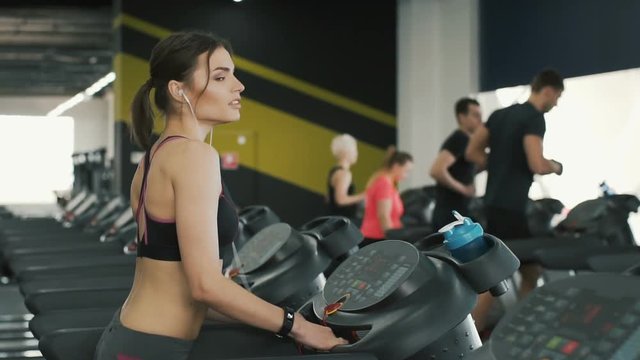 Pretty and young girl jogging in gym