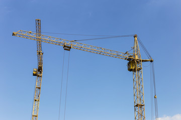 Tower crane against the blue sky.