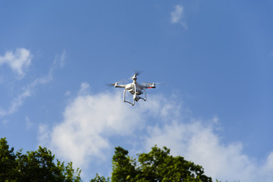 Drone flying against cloudy blue sky. place for text.