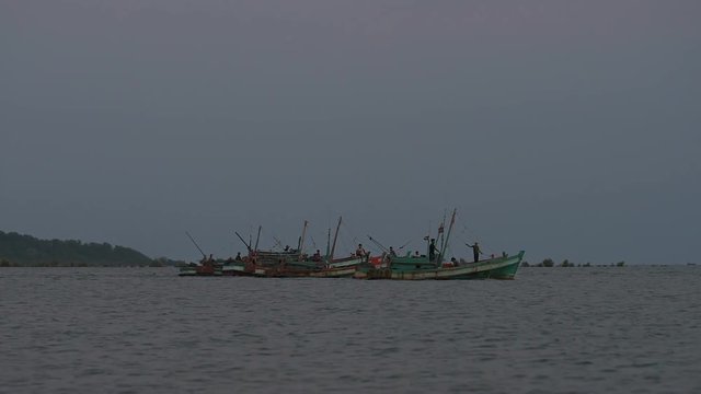 Every day a 6:30 pm Khmer fishermans are going out to sea for fishing. They connect their boat into four or six making one big boat to save fuel. 31 may 2018 Kampot area, Cambodia. 