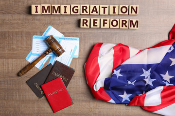Fototapeta na wymiar Cubes with text IMMIGRATION REFORM, judge's gavel and American flag on table