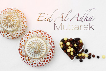Eid Al Adha sacrifice festival, Islamic Arabic candle and sweet chocolate sugars. Eid al adha...