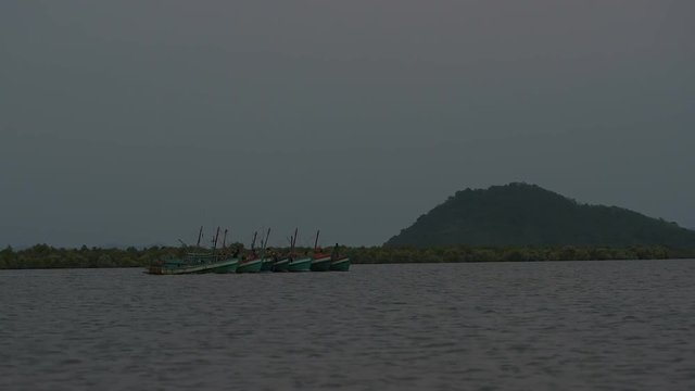 Every day a 6:30 pm Khmer fishermans are going out to sea for fishing. They connect their boat into four or six making one big boat to save fuel. 31 may 2018 Kampot area, Cambodia. 