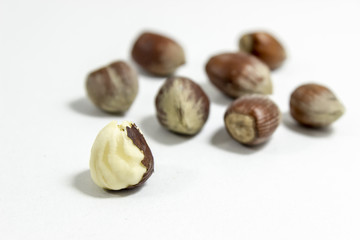 Close-up shot of couple hazelnuts with blurry white background