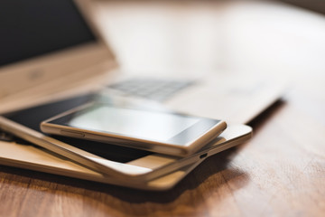 phone and tablet on a laptop