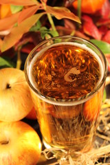 cider in glass surrounded by apples