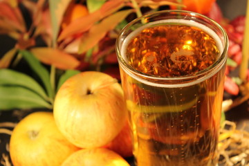 cider in glass surrounded by apples