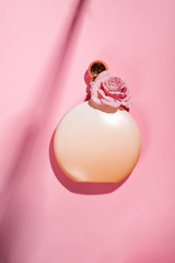 Pink natural cosmetic products gel, lotion, serum or toner roses on pink background