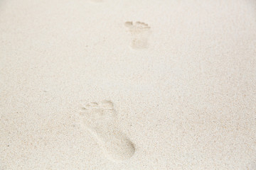 Fototapeta na wymiar Foot print on the sand at the beach background