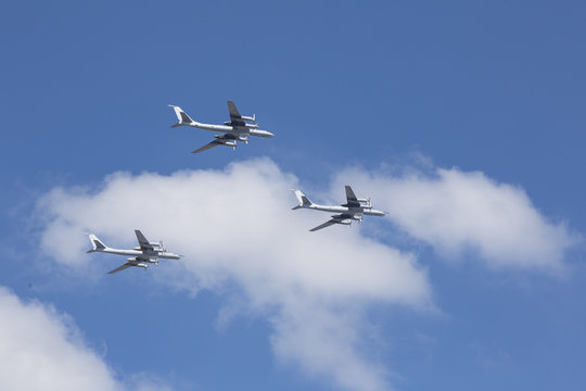 Beautiful picture of several planes flying in blue sky.