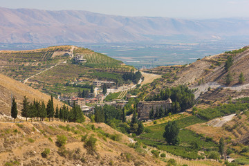 Fototapeta na wymiar Panorama of the Bekaa Valley landscape with the Niha Roman temple, vineyard hills and mountains, in Zahle, Lebanon